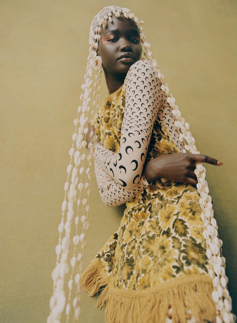 Changkou embraces a fitful mix of patterns and a curtain of cowrie shells in a Marine Serre top  and skirt  and...