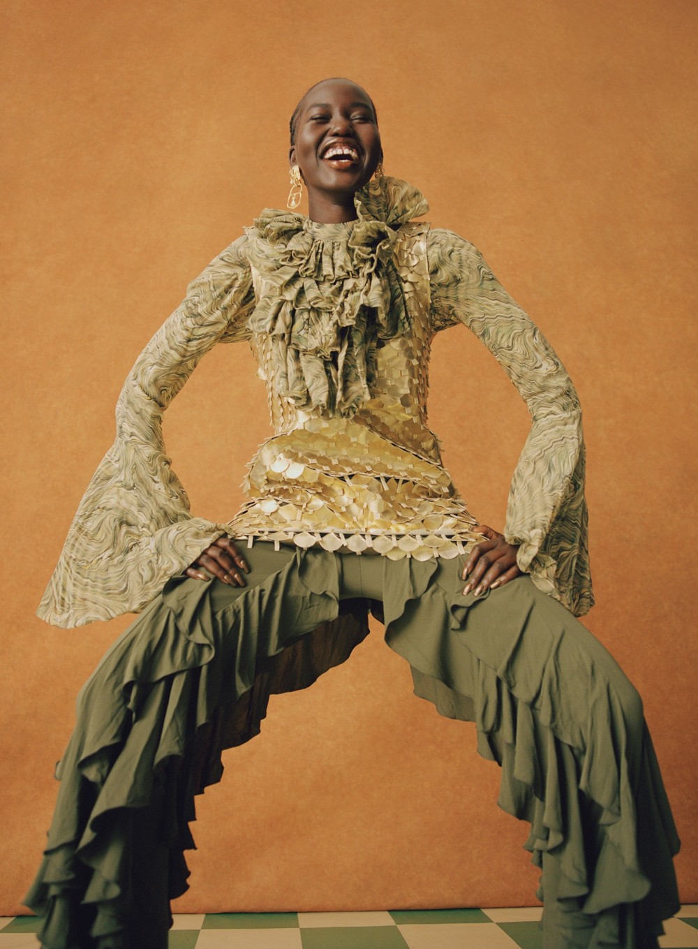 Akech has evidently taken a shine to this JW Anderson metallic tunic ruffled top and jersey pants  jwanderson.com....
