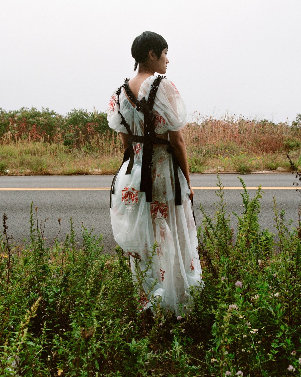 Image may contain Clothing Apparel Fashion Robe Gown Evening Dress Human Person and Plant