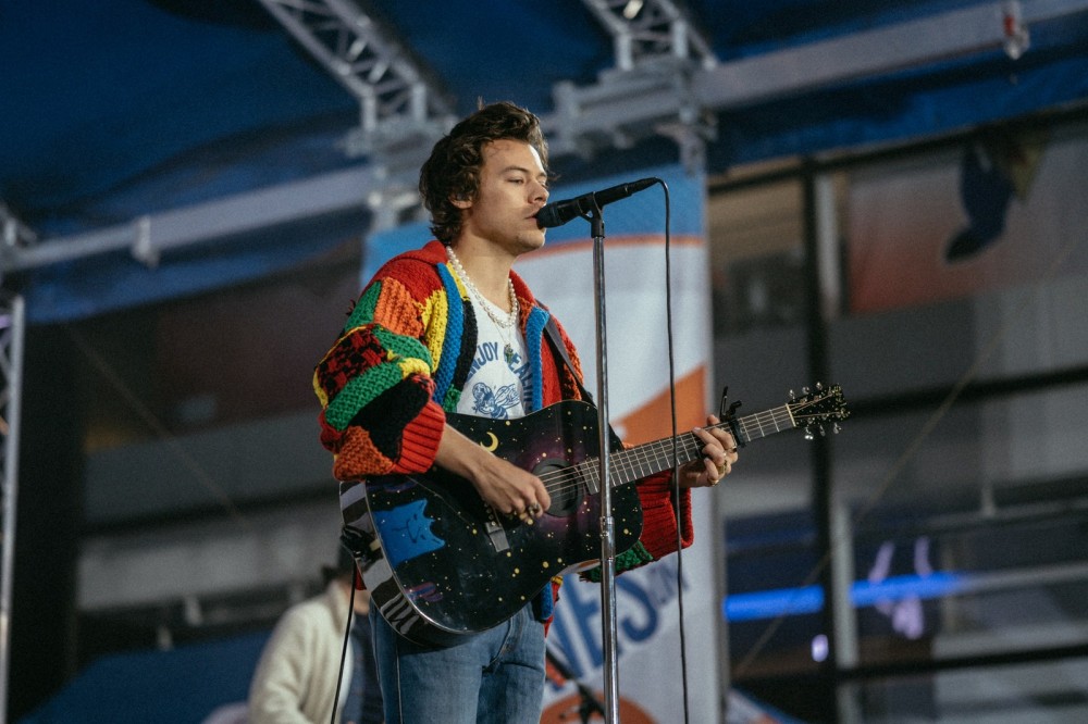 Image may contain Musical Instrument Guitar Leisure Activities Human Person Electric Guitar Musician and Harry Styles