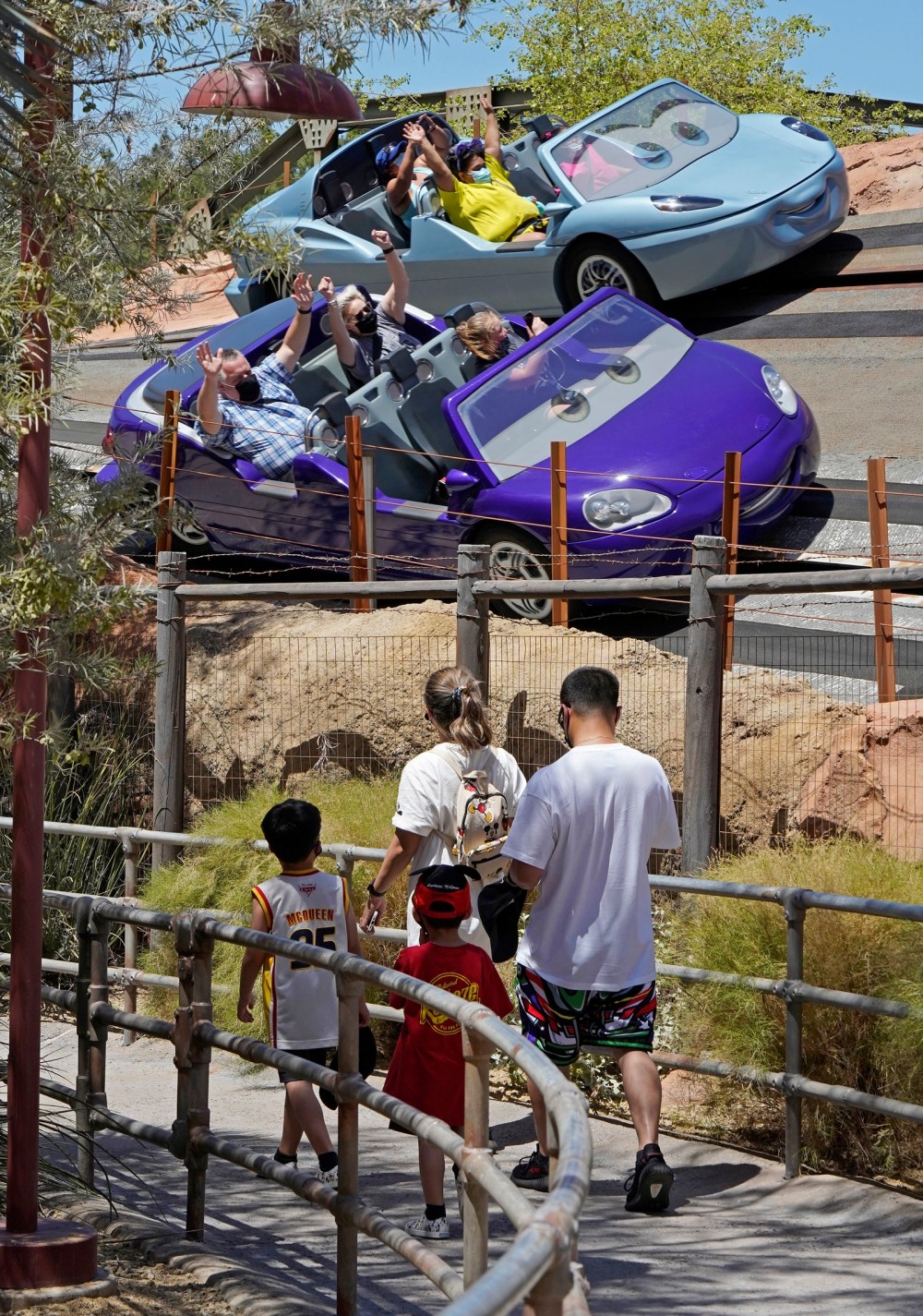 Image may contain Human Person Transportation Vehicle Automobile Car Wheel Machine Amusement Park and Theme Park